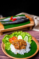 Sambal Peda, Indonesian Traditional Food in white bowl decorated with chiles and onion and garlic on wooden table and golden cloth