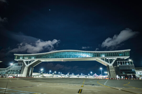 Hong Kong, 25 Aug, 2021, Night view of the Sky bridge at Hong Kong International airport, the sky bridge is almost finish and ready for operation 
