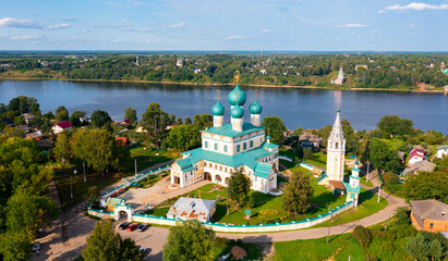 Fototapeta na wymiar Scenic aerial view of Orthodox Resurrection Cathedral on background of green townscape of Tutayev and Volga river on summer day, Yaroslavl region, Russia