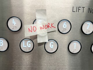 A no work sign on the buttons of an out of service lift elevator  © Regis