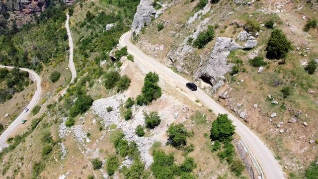 Black Car Driving On The Road In Kadisha Valley, North Governorate, Lebanon. aerial tilt-up
