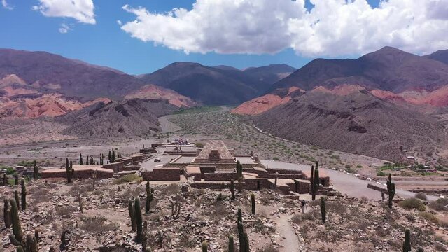 Aerial view of a small village with an Inca temple in the middle of a mountainous and desert valley in Jujuy, Pucar&aacute; Argentina. 4K footage of travel and tourism concept in South America.