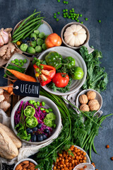 Vegan food assortment on dark background.