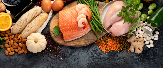 Healthy food assortment on dark background.