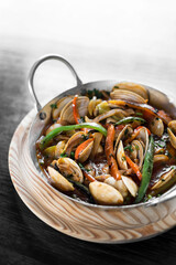 mediterranean clam and vegetable stew in pot at barcelona restaurant