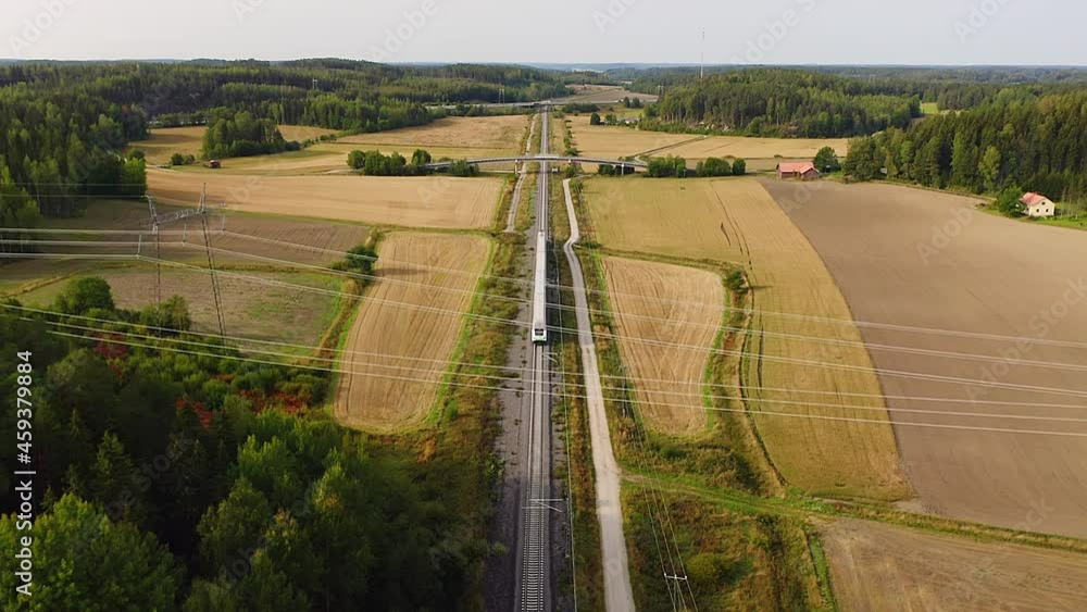 Poster high altitude tracking aerial drone view of high speed passenger train traveling on long straight tr