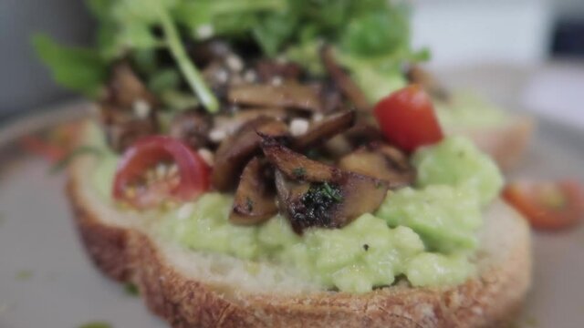 Vegan Plant Based Healthy Avocado Toast with Mushroom Cherry Tomatoes and Rucola