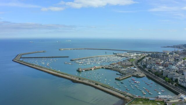 D&uacute;n Laoghaire Harbour as seen from Seapoint, Monkstown, Dublin, Ireland, September 2021. Drone pushes along the west pier with Dublin bay in the distance.