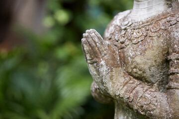 Fototapeta na wymiar Ancient Buddha statue, closeup. In a quiet and comfortable natural environment 