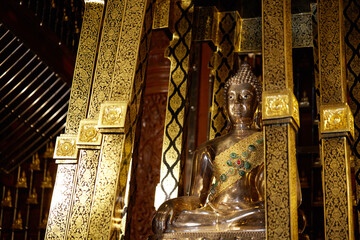 Golden Buddha statues, inside the temple. Chiang Mai, Thailand