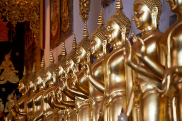Fototapeta na wymiar Golden Buddha statues, inside the temple. Chiang Mai, Thailand