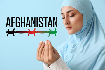 Praying Afghan woman on color background