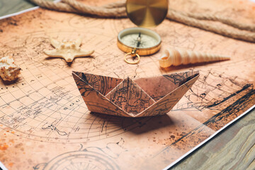 Paper boat on vintage world map