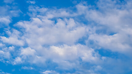 Naklejka na ściany i meble Background of blue sky with beautiful natural white clouds.