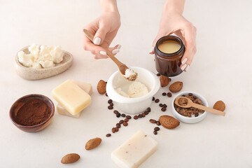 Woman making natural soap on white background