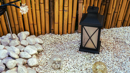 A lamp with the bamboo wall in background