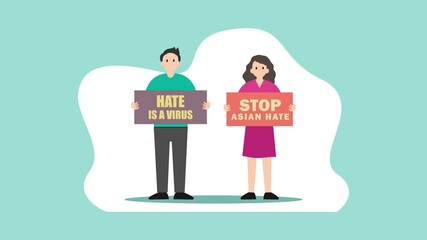 Two people showing poster stop asian hate