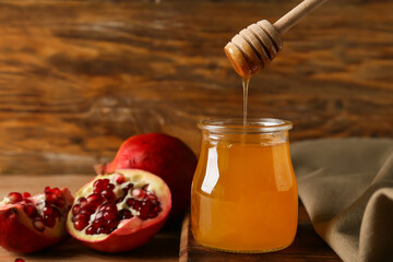Sweet honey and pomegranate on wooden table