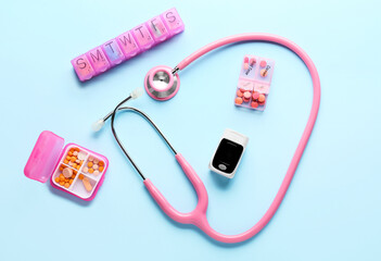 Composition with pulse oximeter and stethoscope on color background