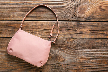 Stylish handbag on wooden background