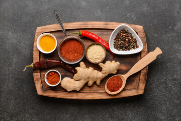 Board with traditional Indian spices on dark background