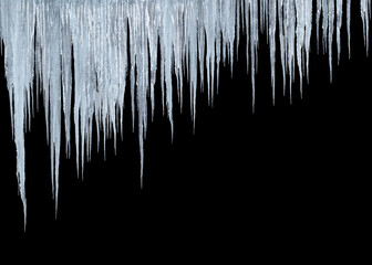 group of long icicles isolated on black