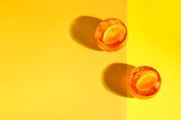Glasses of Aperol spritz cocktail on color background