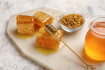 Board with honey combs on light background