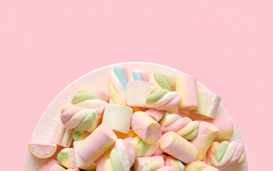 Plate with tasty marshmallows on color background, closeup