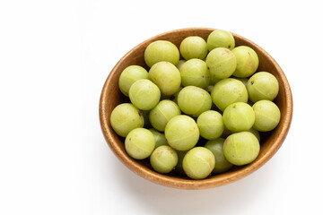 Fresh emblica in wooden bowl white background.