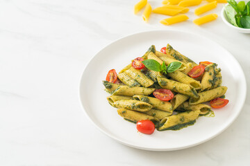 penne pasta with pesto sauce and tomatoes