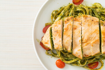fettuccine spaghetti pasta in pesto sauce with grilled chicken