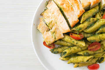 penne pasta in pesto sauce with grilled chicken