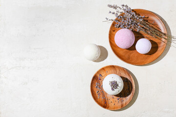 Composition with bath bombs and lavender flowers on light background