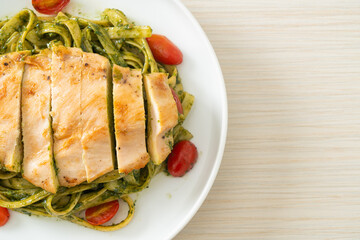 fettuccine spaghetti pasta in pesto sauce with grilled chicken