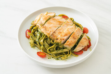 fettuccine spaghetti pasta in pesto sauce with grilled chicken