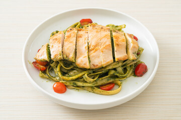 fettuccine spaghetti pasta in pesto sauce with grilled chicken