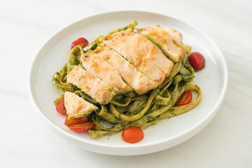 fettuccine spaghetti pasta in pesto sauce with grilled chicken