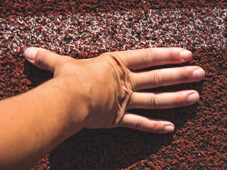 Female wrist with outstretched fingers at the starting line