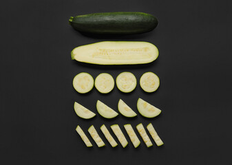 Slices of fresh zucchini squash on dark background