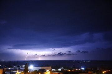 Fototapeta premium Dark sky with lightning over city
