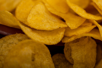 Potato chips scattered on the table, close-up, selective focus.