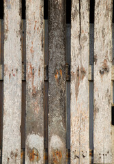 old split wooden planks nailed together with lace. shades of grey, black and brown. ventilation grille from an old barn.