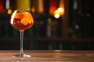 Glass of tasty aperol spritz cocktail on table