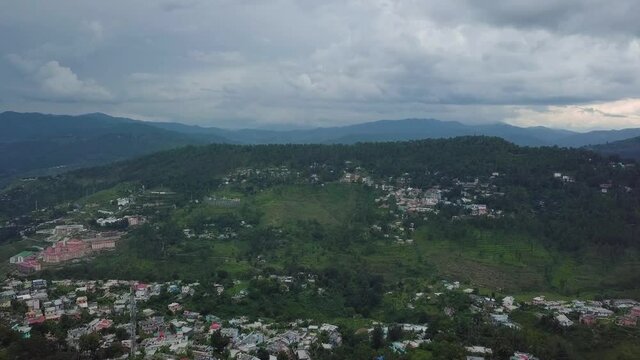 Aerial View of Almora surrounded by Greenery and Blue Sky. Cinematic Drone Shot of Kasar Devi Temple Almora, Uttarakhand, India.