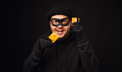 Funny thief holding credit card