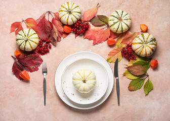 Stylish table setting and autumn decor on color background