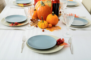 Stylish table serving with rowan and autumn leaf in restaurant