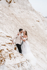 Beautiful wedding couple bride and groom at wedding day outdoors at ocean beach. Happy marriage...