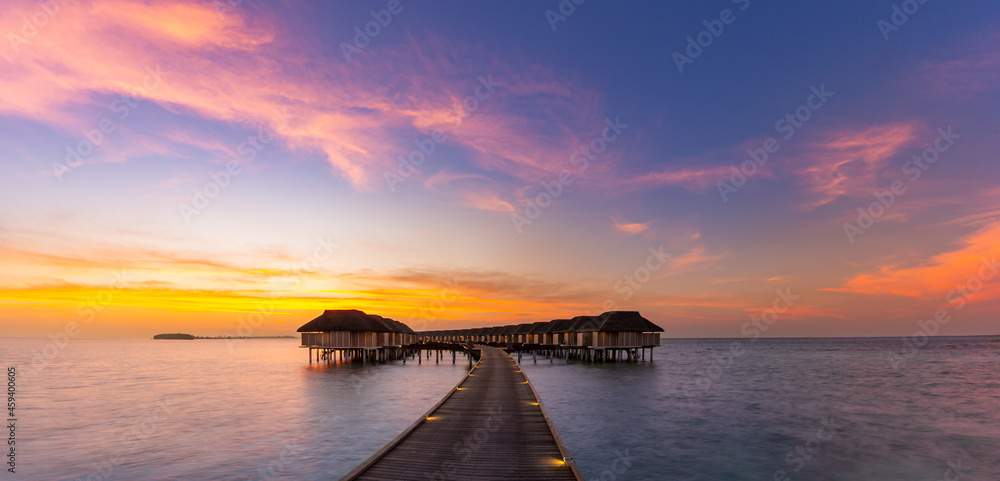 Wall mural Maldives island sunset. Water bungalows resort at islands beach. Indian Ocean, Maldives. Beautiful sunset landscape, luxury resort and colorful sky. Artistic beach sunset under wonderful sky
 - Wall murals